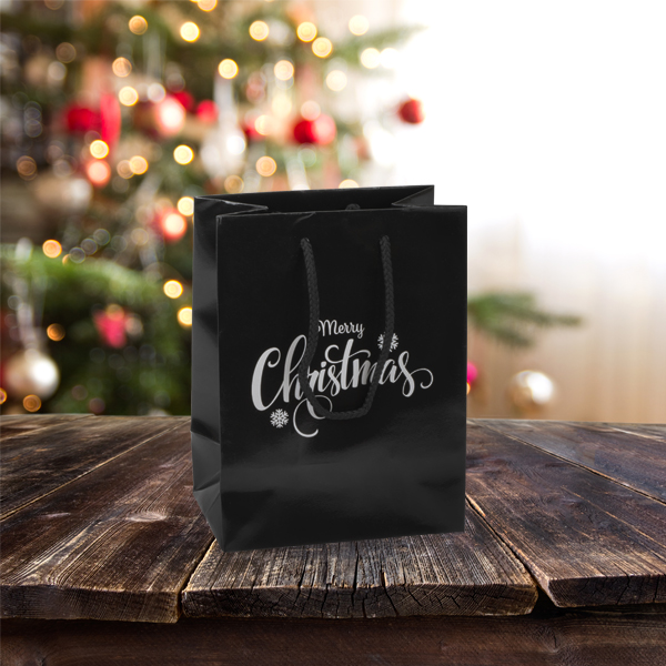 Merry Christmas Carrier Bags in black with a silver Christmas print on one side of the bag. Available from stock at Midpac Packaging